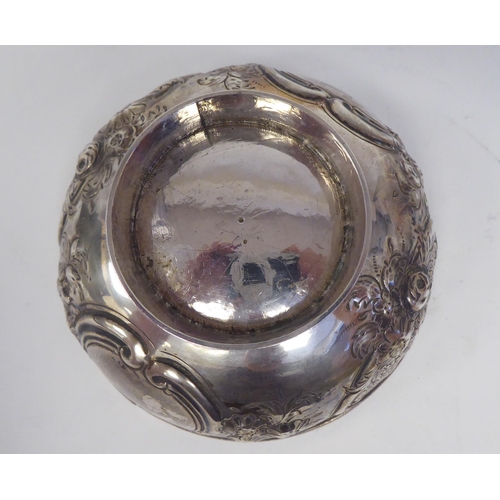 331 - A 19thC Irish silver footed bowl, embossed and chased with scrolls, vignettes and flora  bears ... 