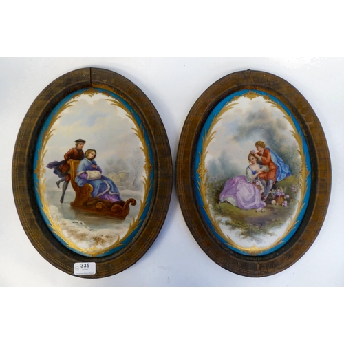 335 - A pair of late 19thC Continental painted porcelain plaques, one featuring a young woman on a sledge,... 