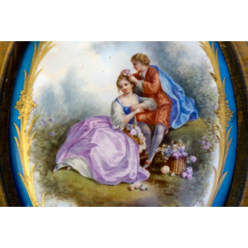 335 - A pair of late 19thC Continental painted porcelain plaques, one featuring a young woman on a sledge,... 