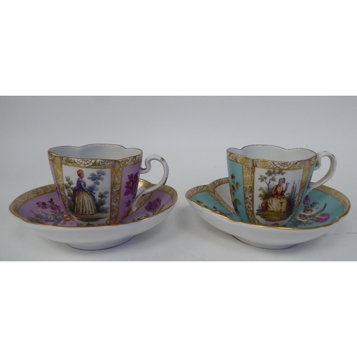 337 - A pair of late 19thC Austrian porcelain cups and saucers of oval outline, decorated in panels with f... 