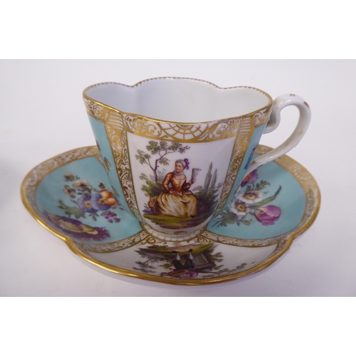 337 - A pair of late 19thC Austrian porcelain cups and saucers of oval outline, decorated in panels with f... 