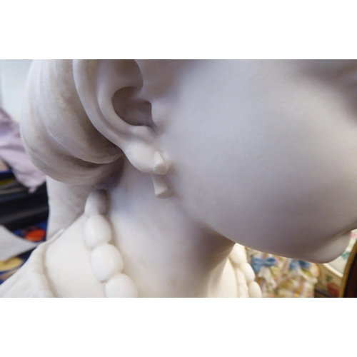 339 - A mid 19thC carved marble bust, a young woman, her hair tied up, wearing a pendant necklet  inscribe... 