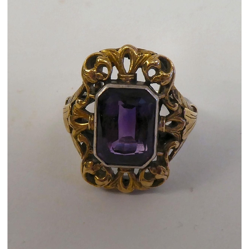 341 - A Sybil Dunlop bicoloured metal dress ring, set with an amethyst