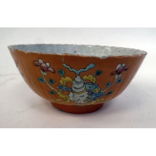 343 - A Chinese porcelain, ribbed, footed bowl, decorated in colours with stylised designs, on a pale ochr... 