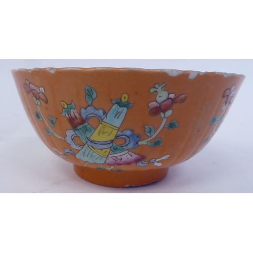 343 - A Chinese porcelain, ribbed, footed bowl, decorated in colours with stylised designs, on a pale ochr... 