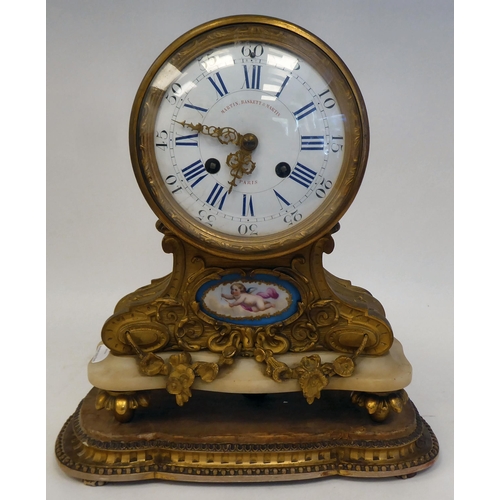 344 - A 19thC French gilt metal, drum cased mantel clock, on an onyx plinth and platform; the bell strike ... 