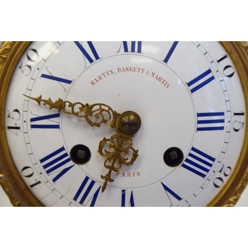 344 - A 19thC French gilt metal, drum cased mantel clock, on an onyx plinth and platform; the bell strike ... 