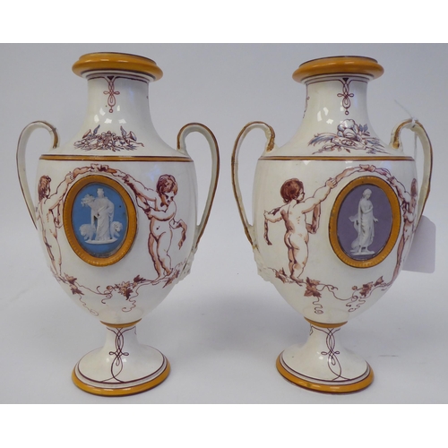 346 - A pair of 19thC Wedgwood cream glazed earthenware, twin handled, ovoid shape, pedestal vases, decora... 