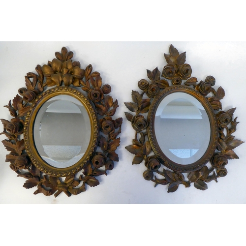 347 - A pair of late 19thC bevelled edge, oval mirrors, set in carved, giltwood, bead bordered, foliate de... 