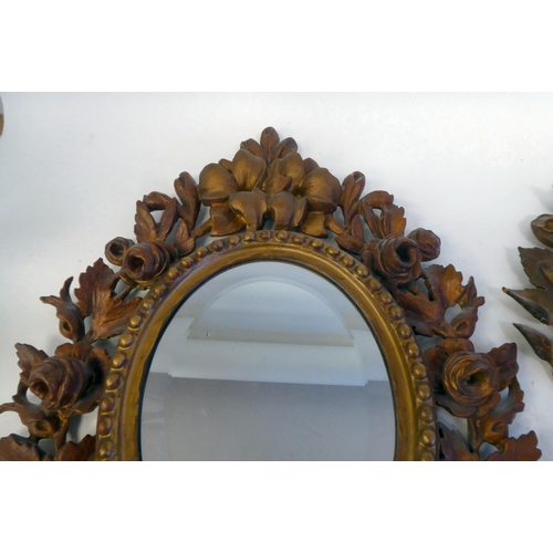 347 - A pair of late 19thC bevelled edge, oval mirrors, set in carved, giltwood, bead bordered, foliate de... 