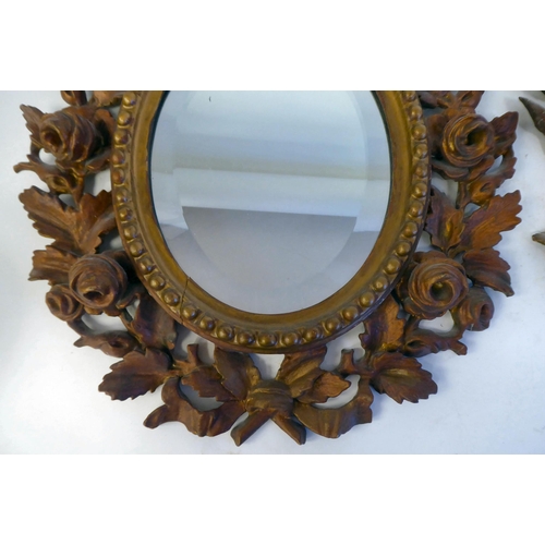 347 - A pair of late 19thC bevelled edge, oval mirrors, set in carved, giltwood, bead bordered, foliate de... 