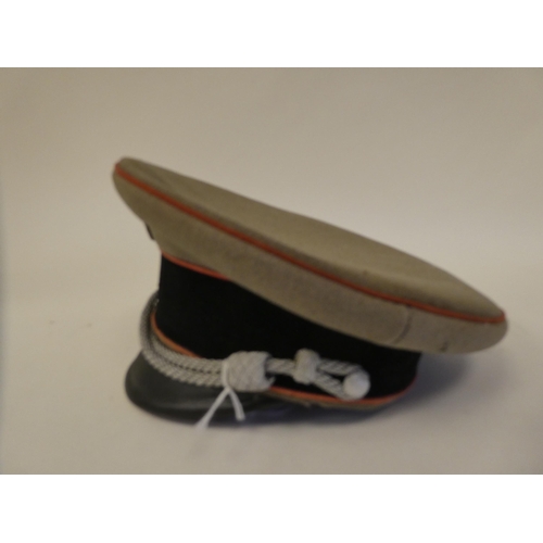 43 - A German Third Reich Waffer SS officer's visor cap with red piping(Please Note: this lot is subject ... 