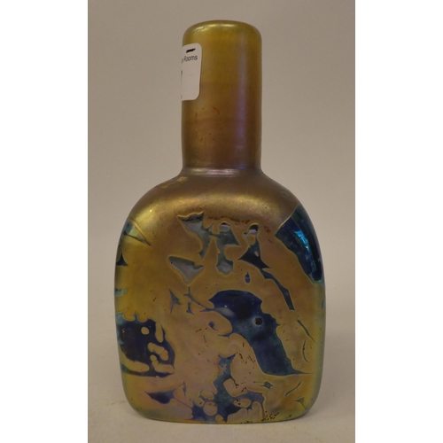 47 - In the manner of Loetz - a glass bottle vase of shouldered, triangular form, randomly decorated in g... 