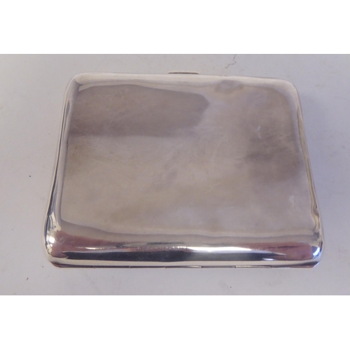 52 - A silver folding cigarette case, the hinged lid on a button clasp, decorated in coloured enamel, fea... 