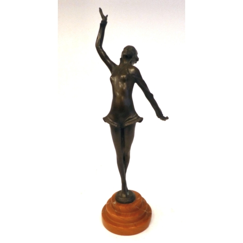 66 - An Art Deco inspired cast and patinated bronze figure, a maiden pirouetting on an iron red, stepped ... 