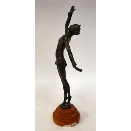 66 - An Art Deco inspired cast and patinated bronze figure, a maiden pirouetting on an iron red, stepped ... 