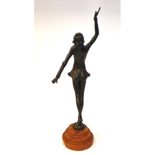 66 - An Art Deco inspired cast and patinated bronze figure, a maiden pirouetting on an iron red, stepped ... 