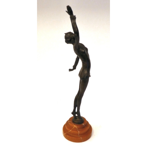 66 - An Art Deco inspired cast and patinated bronze figure, a maiden pirouetting on an iron red, stepped ... 