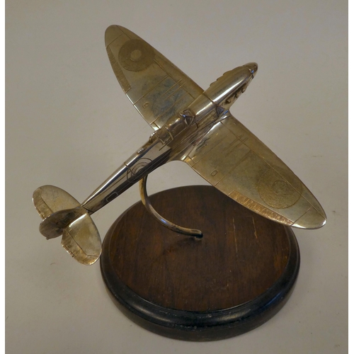 68 - A silver desktop model, a Spitfire, on a hardwood stand  CFL  London 1986  5.75