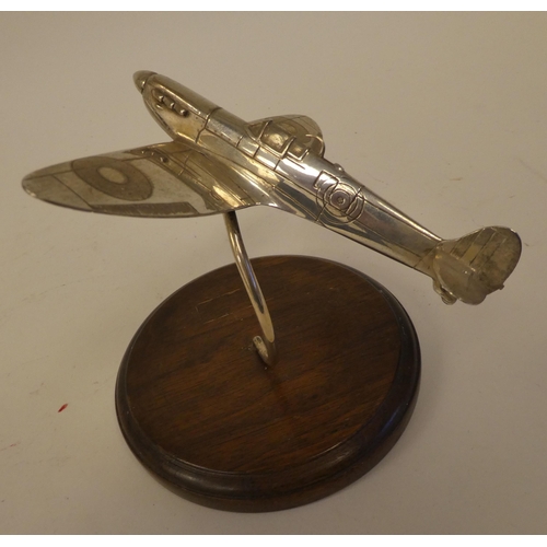 68 - A silver desktop model, a Spitfire, on a hardwood stand  CFL  London 1986  5.75