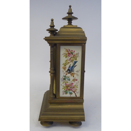 76 - A late 19th/early 20thC three piece brass clock garniture with painted porcelain panels, the clock w... 