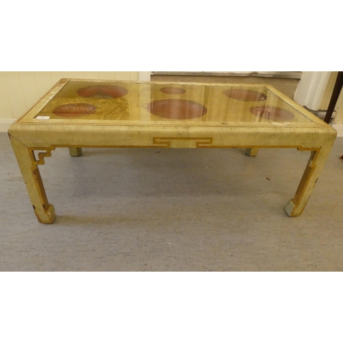 77 - An early 20thC Sino-European crackle painted and gilded wooden coffee table, the top set with glass,... 