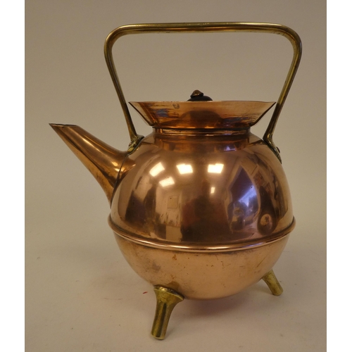 78 - An Arts & Crafts copper and brass kettle of covered cauldron form with an angled spout, cover an... 