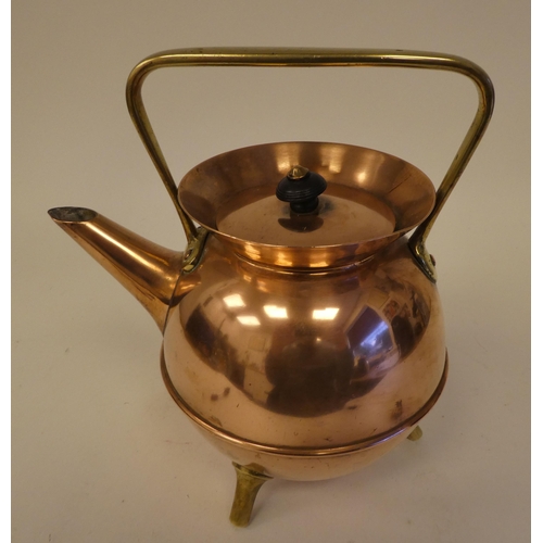 78 - An Arts & Crafts copper and brass kettle of covered cauldron form with an angled spout, cover an... 