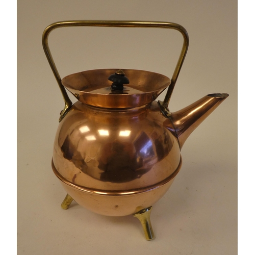 78 - An Arts & Crafts copper and brass kettle of covered cauldron form with an angled spout, cover an... 