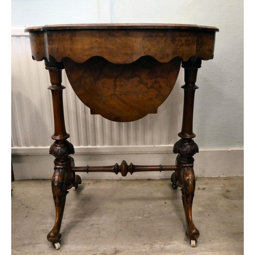 8 - A mid Victorian figured walnut, oval needlework table with marquetry ornament, the quarter veneered ... 