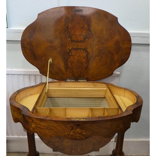 8 - A mid Victorian figured walnut, oval needlework table with marquetry ornament, the quarter veneered ... 