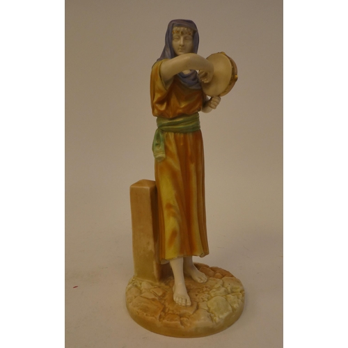 80 - A Royal Worcester painted and gilded china figure, a girl playing a tambourine, on a circular plinth... 