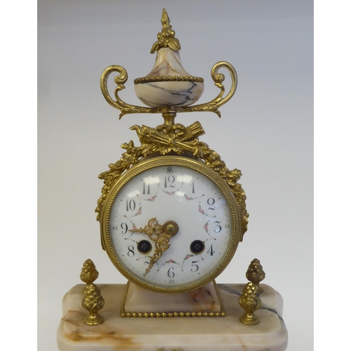 81 - A late 19th/early 20thC French mottled pink marble and gilt metal mounted, three piece clock garnitu... 