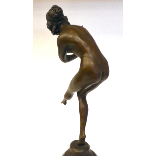 86 - A 19thC style cast and patinated bronze figure, a dancing nude, on a black marble plinth  bears... 