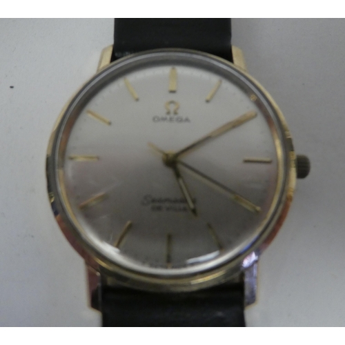 87 - An Omega Seamaster Deville 9ct gold cased wristwatch, faced by a Champagne coloured, gilded baton di... 