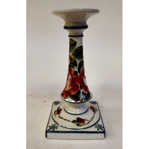 90 - A Wymess pottery candlestick with an integral, flared sconce and tapered stem, on a square base, tra... 