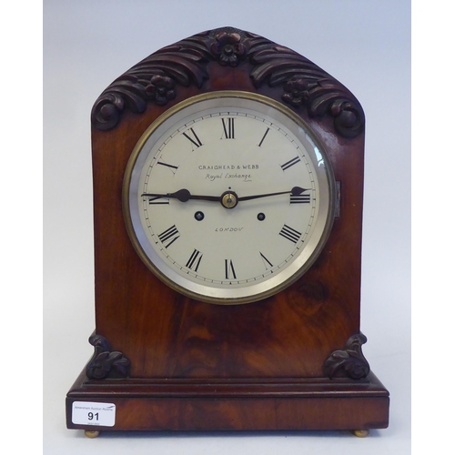 91 - A 19thC mahogany cased, pointed arch top bracket clock with applied, foliate carved mounts, on ball ... 