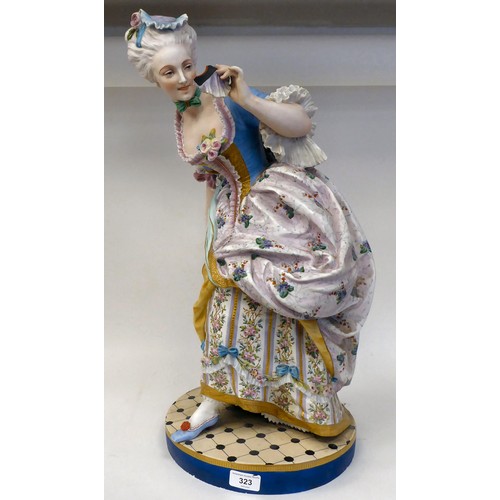 323 - A late 19thC French ceramic figure, a fashionable young lady wearing a floral skirt with a powder bl... 