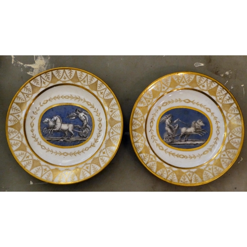 333 - A pair of early 19thC French porcelain plates, decorated with cupid charioteers and gilt ornament, i... 