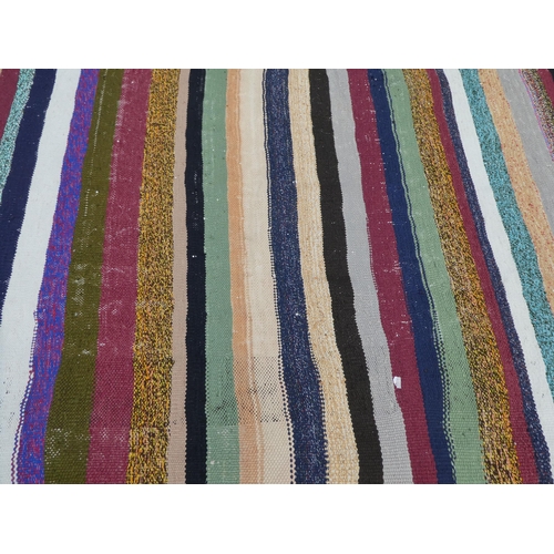 104 - A Kelim rug, decorated with coloured stripes  59