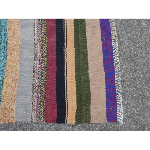 104 - A Kelim rug, decorated with coloured stripes  59