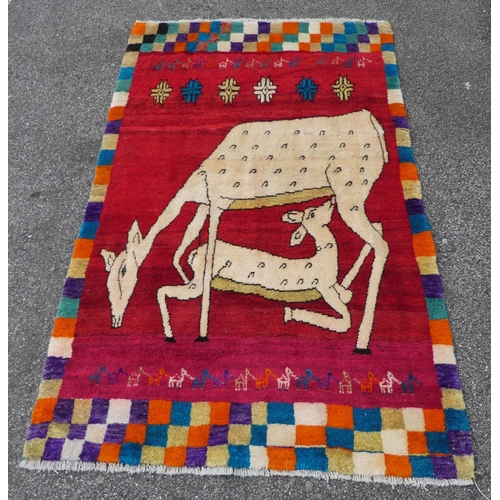 109 - An Iranian pictorial rug, depicting a deer nursing a doe, on a multi-coloured ground  45