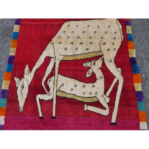 109 - An Iranian pictorial rug, depicting a deer nursing a doe, on a multi-coloured ground  45