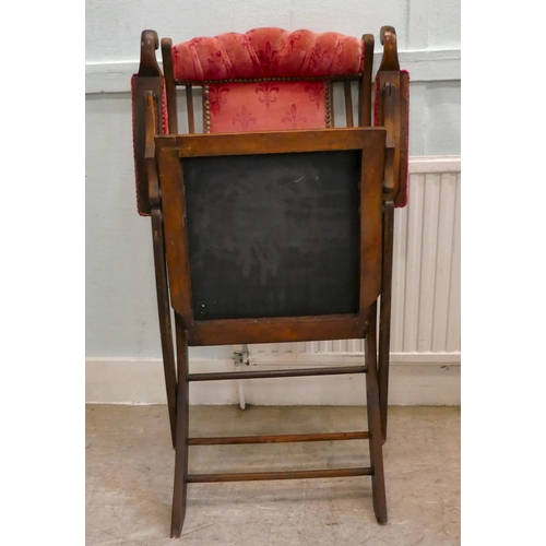 113 - A late Victorian beech framed, folding campaign style veranda chair, button upholstered in studded w... 