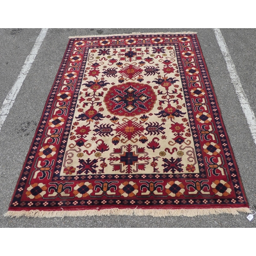 114 - An Afghan style rug, decorated with repeating stylised designs, on a multi-coloured ground  62