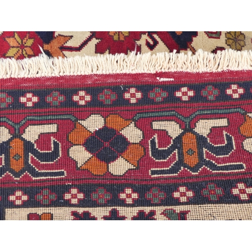 114 - An Afghan style rug, decorated with repeating stylised designs, on a multi-coloured ground  62