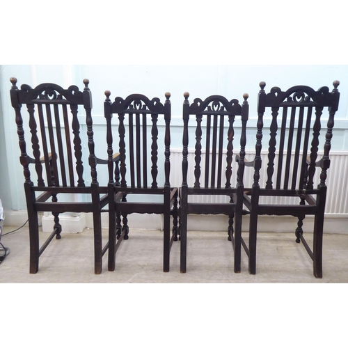 130 - A set of four early 20thC stained oak, carved, pierced and lath back chair frames (only), raised on ... 