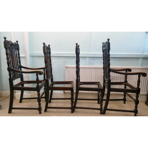 130 - A set of four early 20thC stained oak, carved, pierced and lath back chair frames (only), raised on ... 