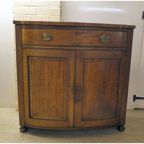 132 - A Regency mahogany bowfront sideboard with a frieze drawer, over two panelled doors, raised on turne... 