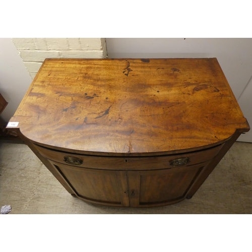 132 - A Regency mahogany bowfront sideboard with a frieze drawer, over two panelled doors, raised on turne... 